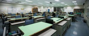 classroom with tilt-adjustable drawing surface desks