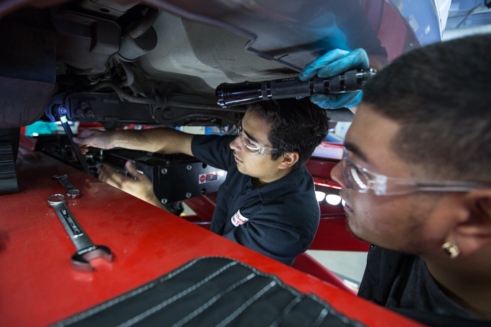 Students gathered around a vehicle, engaged in a troubleshooting exercise at Río Hondo’s automotive technology program