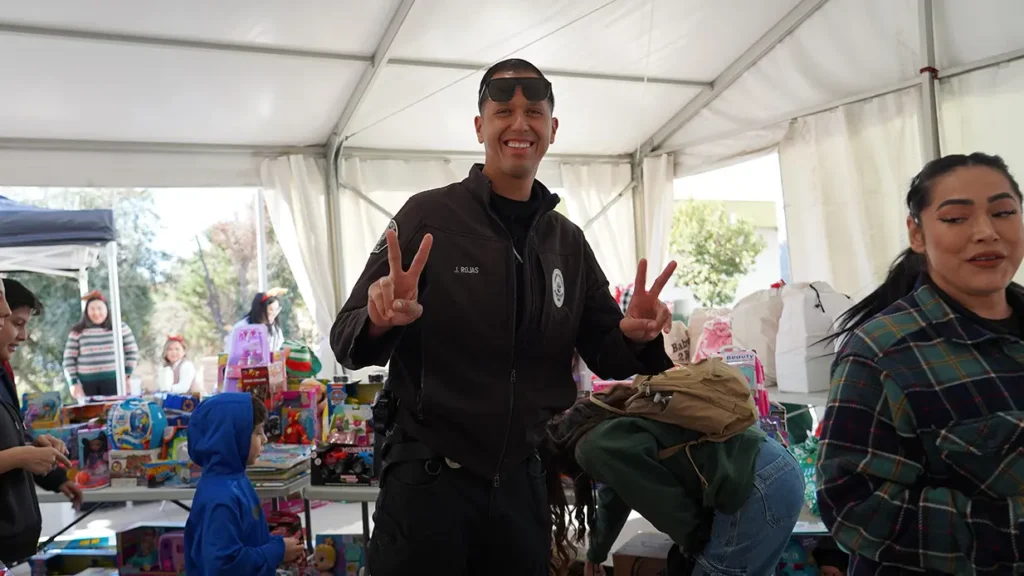 EMPD officer doing peace sign with hands