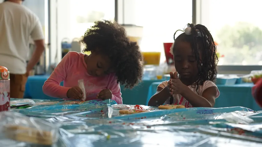 two young girls doing arts and crafts