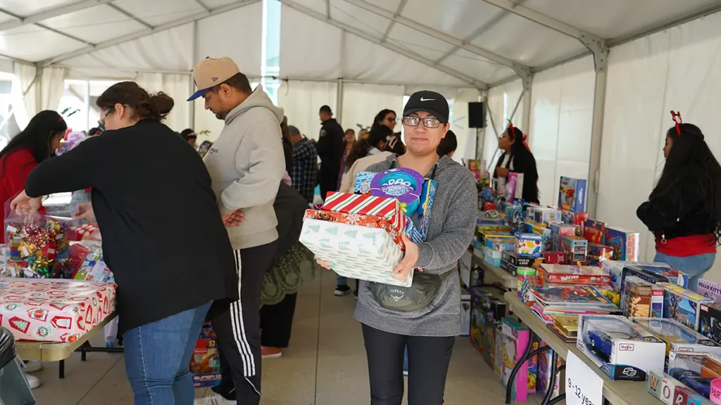 parent holding gifts for kids