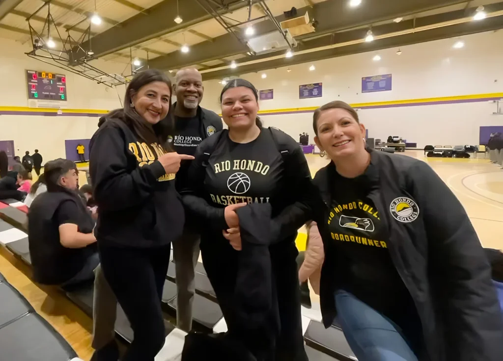 college administrators posing during womens basketball game